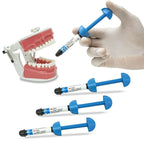Premium 3M ESPE Filtek Z350 XT restorative composite kit in clinical use – dentist hand holding A2 body shade syringe next to dental typodont
