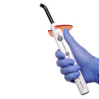 Dentist holding 3M ESPE Elipar DeepCure-L LED Curing Light with gloved hand during dental procedure