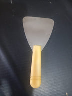Dental Wax Paddle Lab Instrument with stainless steel triangular blade and yellow plastic handle – side view – professional dental lab tool for wax manipulation in denture fabrication and orthodontic appliance fabrication worldwide
