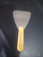 Dental Wax Paddle Lab Instrument with stainless steel triangular blade and yellow plastic handle – front view – durable dental laboratory instrument for wax-up procedures and crown bridge pattern fabrication worldwide
