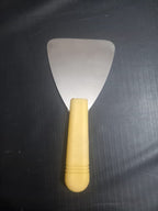 Dental Wax Paddle Lab Instrument with wide stainless steel triangular blade and yellow plastic handle – top view – compact dental lab wax spatula for denture wax-up and general dental laboratory wax work worldwide
