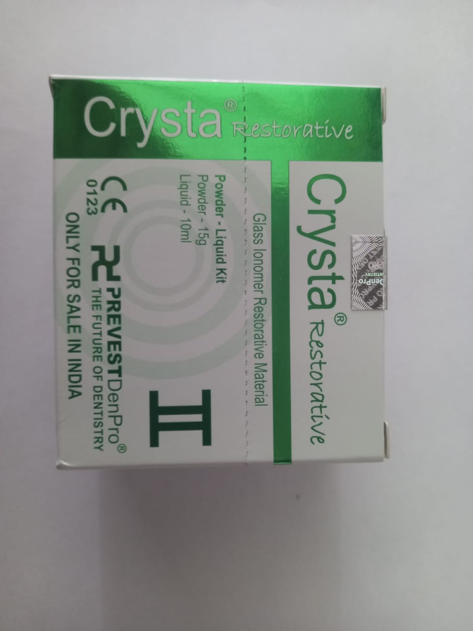 Dentist applying Prevest DenPro Crysta Restorative Glass Ionomer Cement on tooth